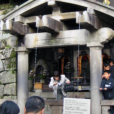 Drinking spring water from the Kiyomizu temple shrine in Kyoto.