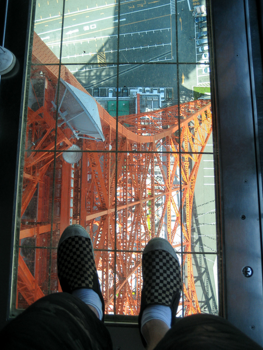 Looking down through a floor window at Tokyo Tower